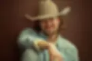 Brian Kelley in a striking solo portrait, representing his transition from Florida Georgia Line to a successful solo career in country music.