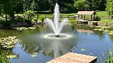 private residential farm pond with a fountain and a small dock.jpg