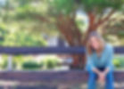 heather sitting on bench smiling.JPG