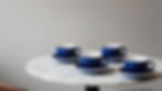 Four blue coffee cups on a marble table in Chandigarh