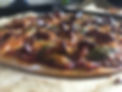 piping hot chanterelle mushroom pizza with green pesto and mozerella