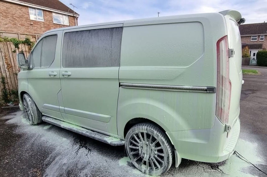 Van covered in green snow foam during detailing in Bristol – deep cleaning in progress