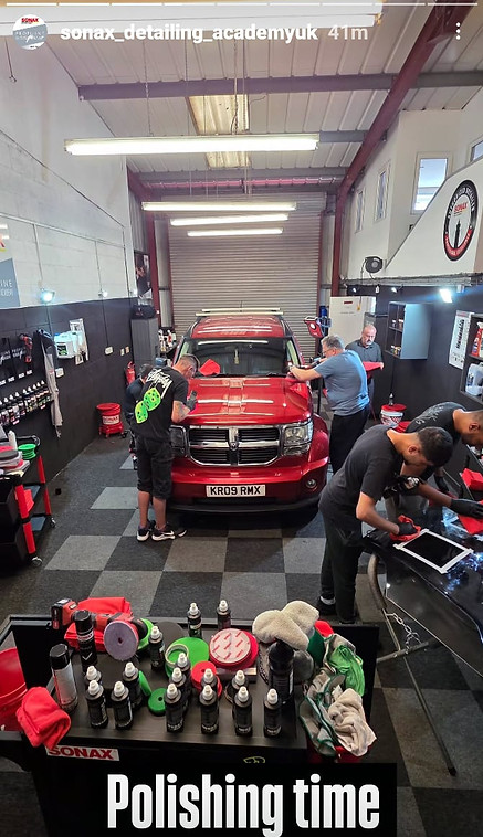 Dazzling Details Ltd team member receiving hands-on training at a Sonax facility, learning advanced vehicle care techniques from certified Sonax instructors.