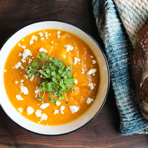 squash soup with goat cheese and kale microgreens