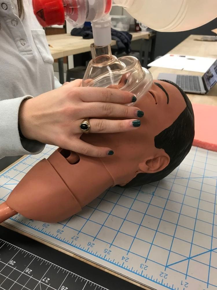 One person handling BVM face mask with 1 hand