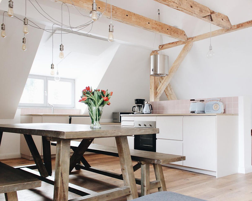 Open kitchen with wooden beams and large dining table in Apartment Roxy