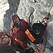 Two ice climbers on a steep icy slope, attached using ice axes and ropes. This is a selfie photo.