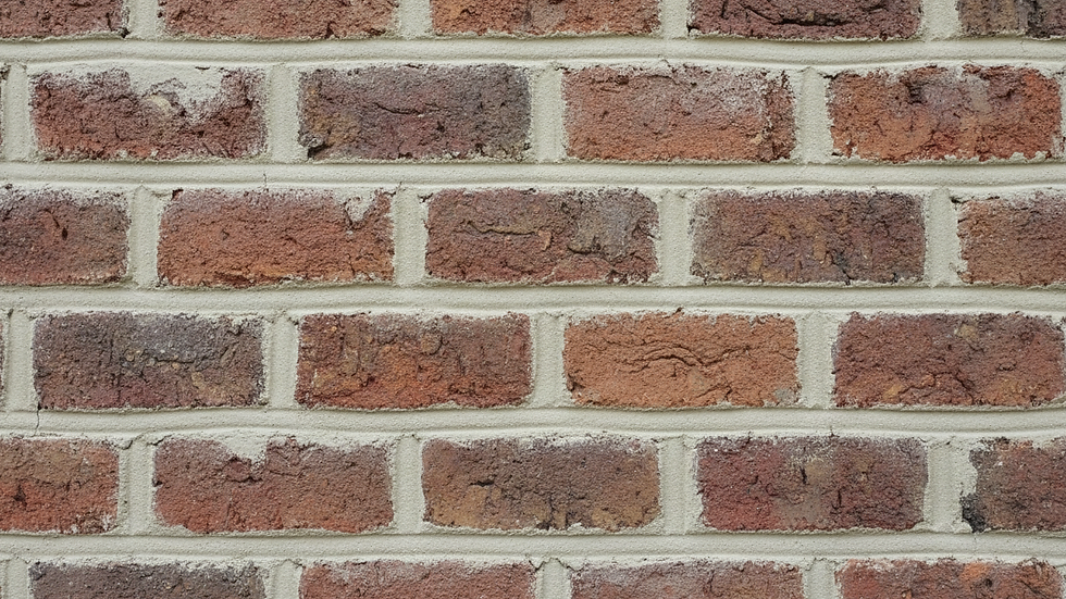 Close-up view of brick wall with fresh mortar joints