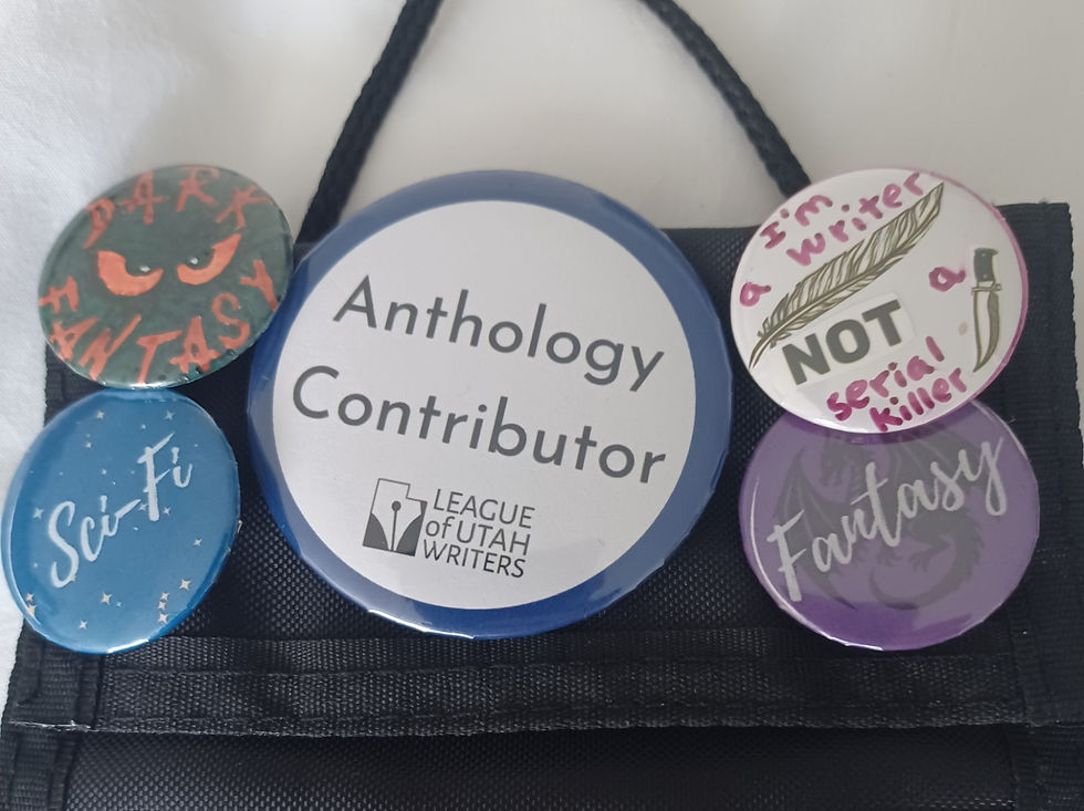 Dark fantasy author shows pins from the writers conference to match her writing genres--Dark Fantasy, I'm a writer not a serial killer, sci-fi, fantasy, anthology contributor