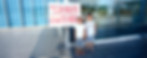 Two kids standing in front of a building next to an easel sign that reads ‘Tour Route Starts Here.’