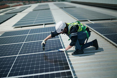 Person working on a roof with solar panels