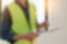 Person in hi-vis holding clipboard