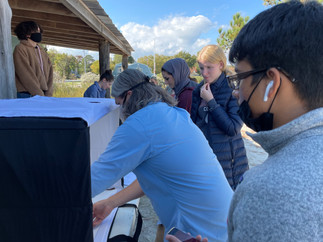 Rob Forloney assists students in photographing objects