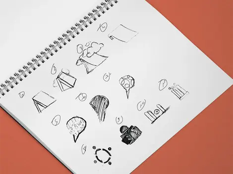 Croquis préparatoire du logo de Des Livres et Nous dans un carnet