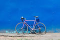 Bike leaning against a blue wall