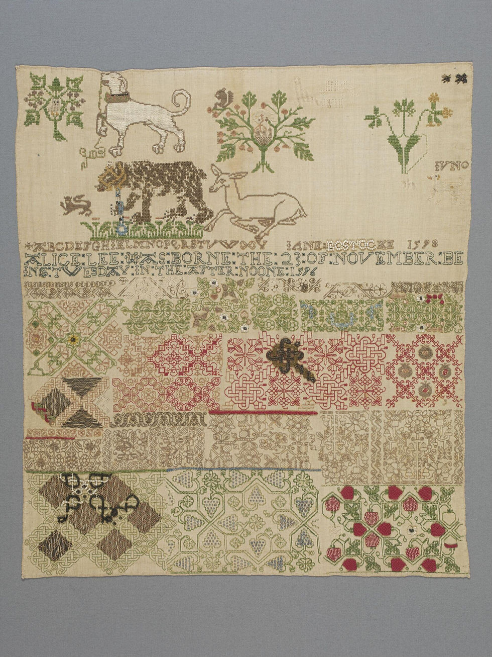 Sampler of embroidered linen with coloured silk and metal threads, seed pearls and beads, made by Jane Bostocke, England, dated 1598, Victoria & Albert Museum