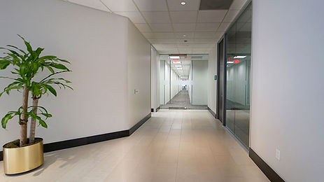 Hallway featuring glass office fronts.