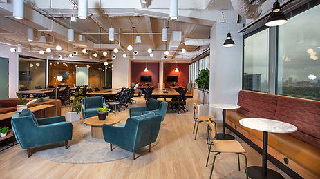 Coworking area with chairs, private booths and large tables.