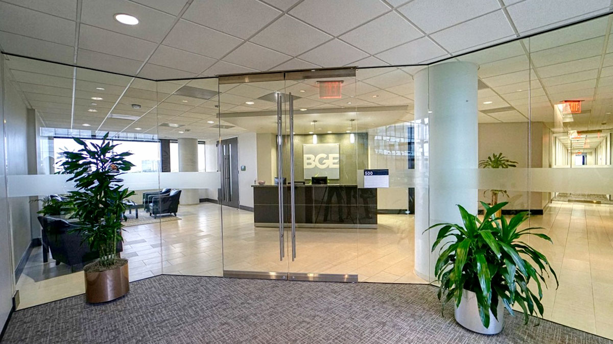 Glass entry, a reception desk, and "BGE" logo signage.