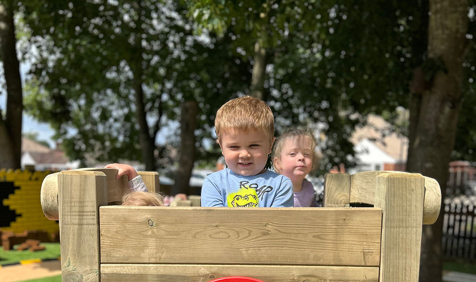 Child playing on EYFS timber climbing frame