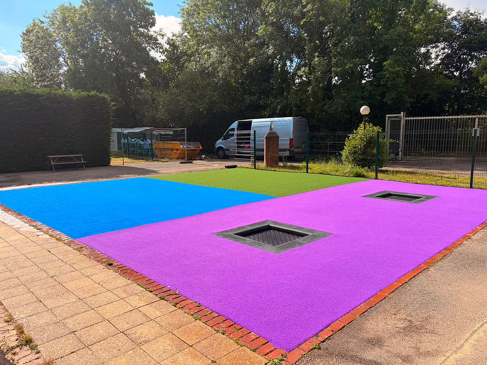 In-ground trampolines in a school playground with colourful artificia lgrass surfacing