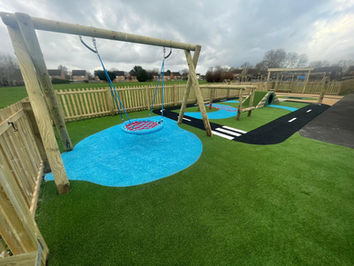 SEND playground with swing, equipment and themed artificial grass