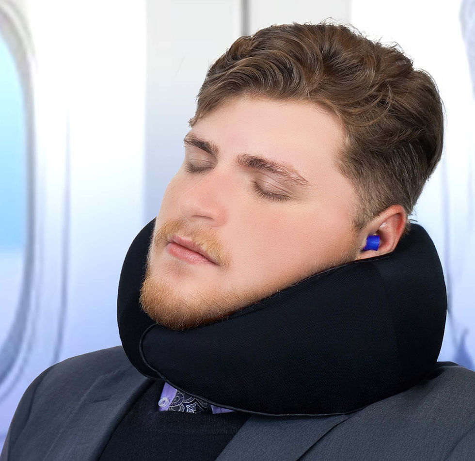 Man sleeping on an airplane wearing a black memory foam travel neck pillow and blue earplugs.
