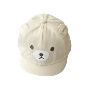 Cream baby cap with bear face
