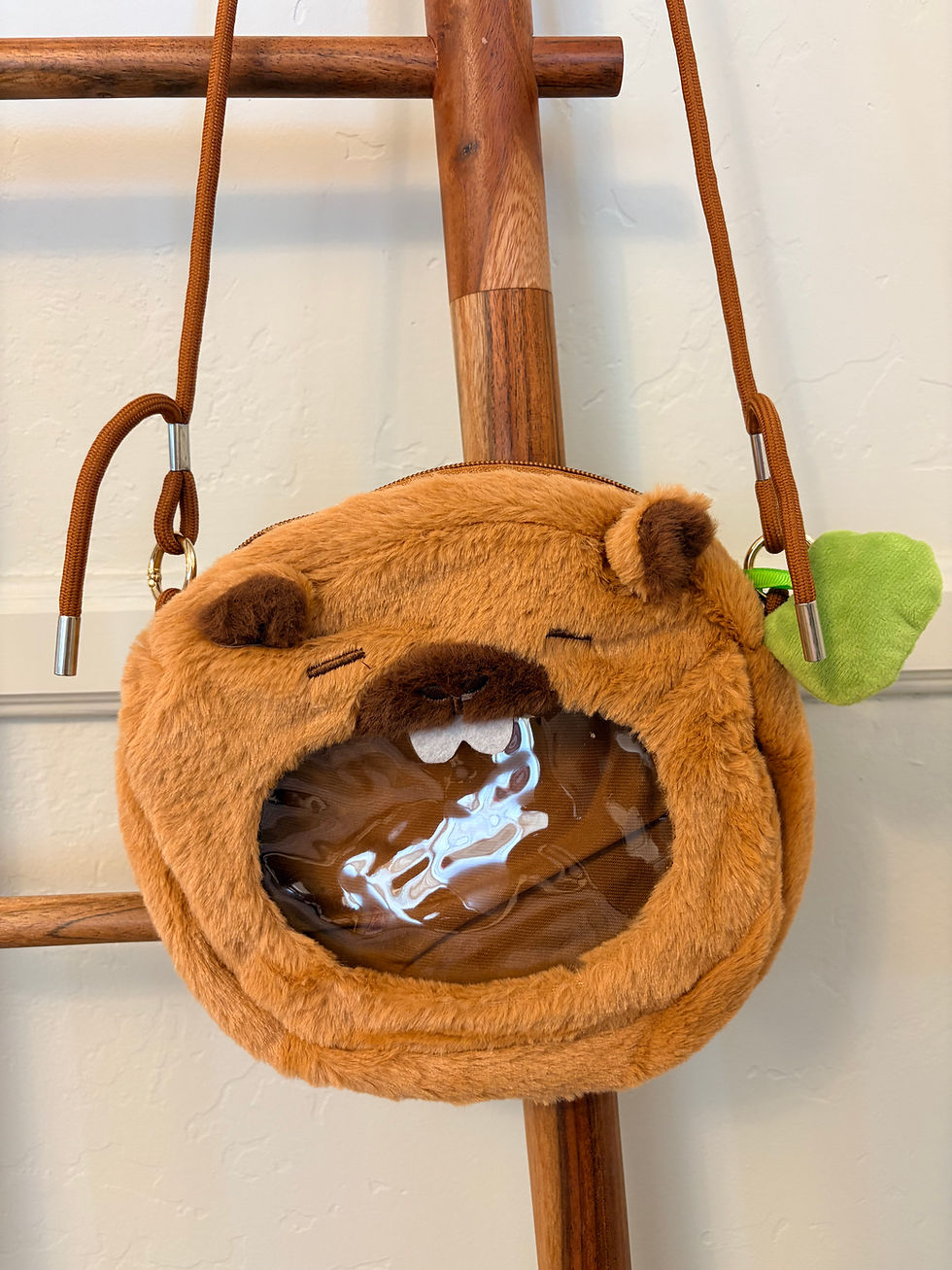 Fuzzy brown bear bag with clear window and green charm