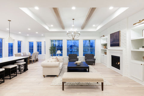 Modern open-plan living room with fireplace and white decor