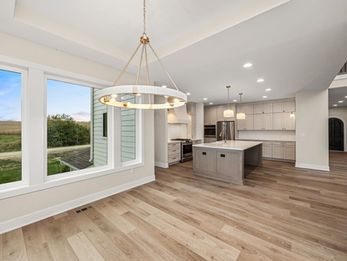 Modern open kitchen and dining area with island and large windows