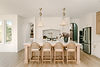 Modern kitchen island with cane stools and pendant lights