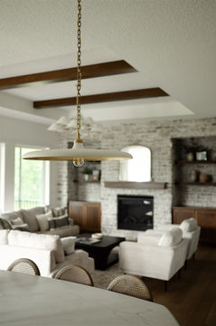 Bright modern living room with fireplace and chandelier
