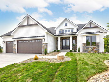 Modern white house with stone accents, two-car garage