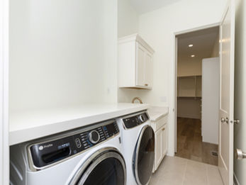 Laundry room with white washer and dryer