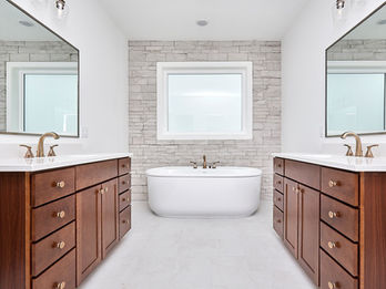 Modern bathroom with dual vanities and freestanding tub