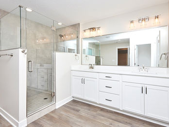 Modern bathroom with double vanity and glass shower
