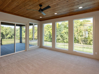 Room with wooden ceiling, fan, and large windows