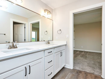 Modern bathroom with double vanity, two sinks, and large mirror