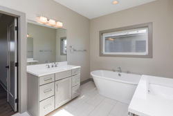 Spa Like Light Gray Master Bathroom in New Home
