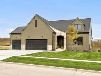 Modern stucco and stone house with two-car garage