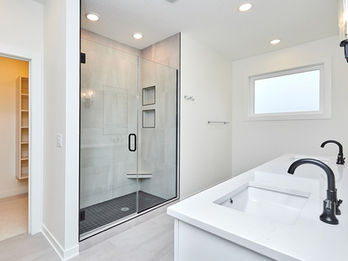 Modern bathroom with walk-in shower, dual sinks