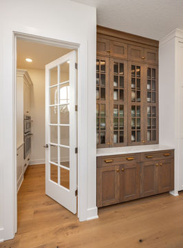Open French door, wooden cabinet with glass doors and counter
