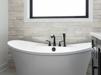 Freestanding white tub with matte black fixtures