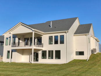 Rear of a modern house with balcony and grassy slope