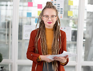 Corporate employee, with classy dreadlocks in a business meeting room.