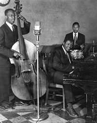 Oscar Peterson Trio: Austin Roberts (bass), Clarence Jones (drums), and Oscar Peterson (piano) at the Alberta Lounge.