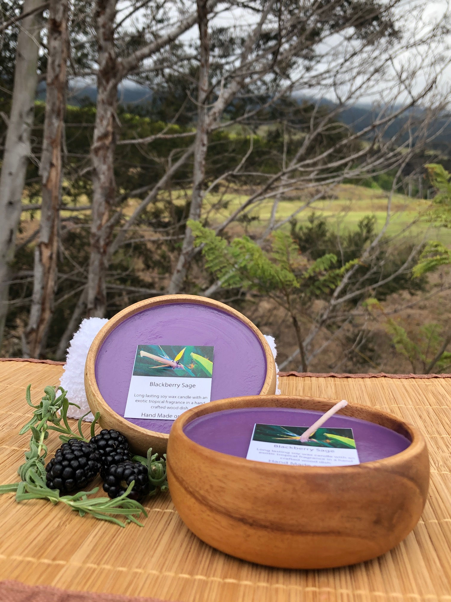 Blackberry Sage Soy Wax Candle in a Monkeypod Wood Bowl. Purple in Color. Smells like Blackberries with Sage & Basil Herbs