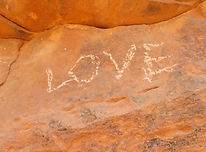 "love" carved into a rock wall