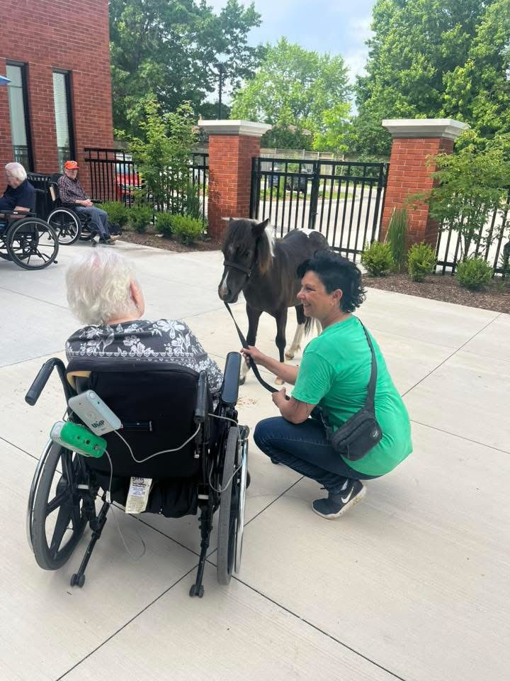 Sparkles giving kisses to a senior! What Joy on her face!